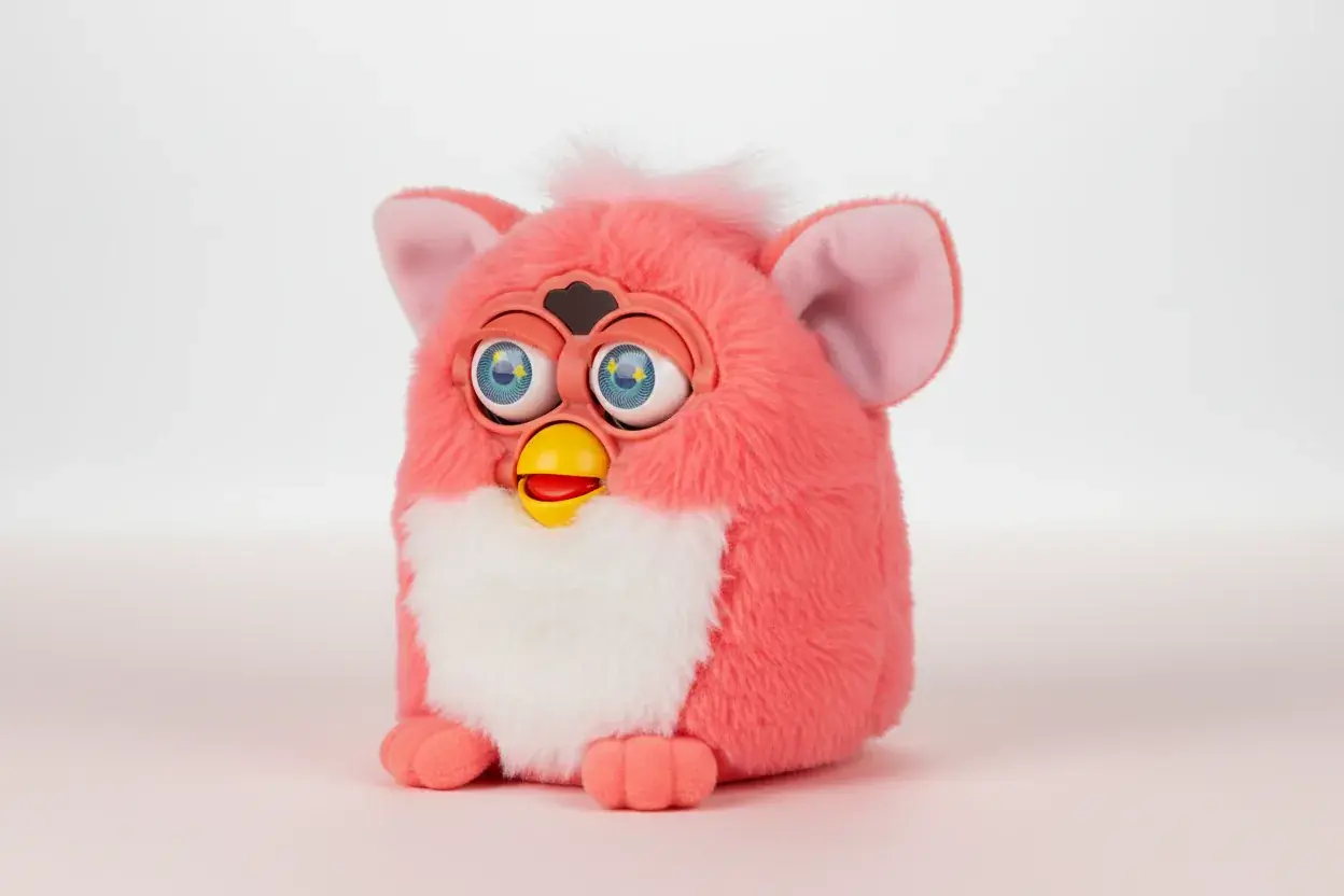 Classic Furby electronic plush toy in coral pink color showing detailed features and design