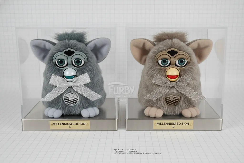 Two Millennium Furby versions side-by-side comparison showing subtle color and tag differences