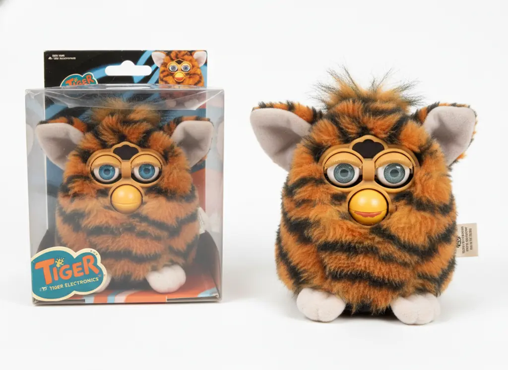 Side-by-side comparison showing mint condition 1998 Furby versus well-loved used Furby