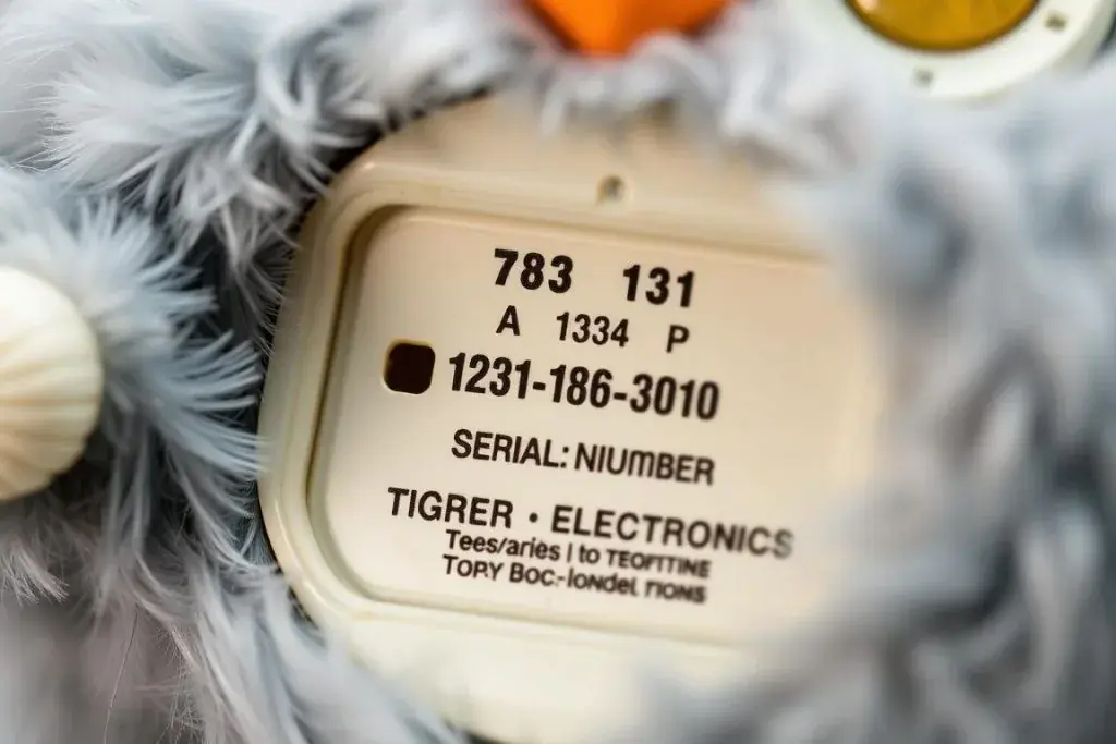 Original Furby with battery compartment open showing where to check for authenticity marks Original Furby with battery compartment open showing where to check for authenticity marks